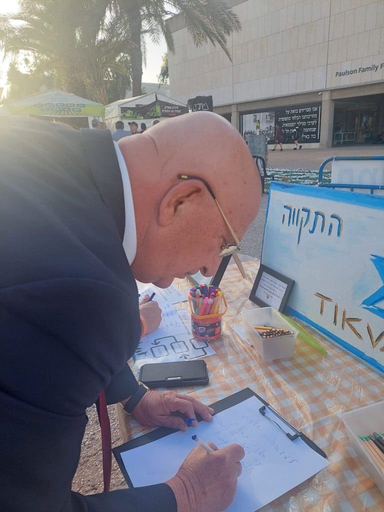 עו״ד ששי גד שולח תקווה ב'שולחן התקווה' בכיכר החטופים והנעדרים TLV​